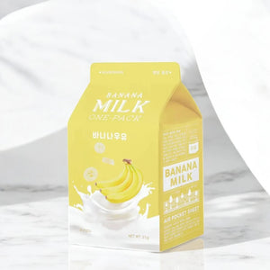 Skin TOGO A'pieu Milk One Pack banana sheet mask in a yellow carton-shaped package with milk and banana illustrations.