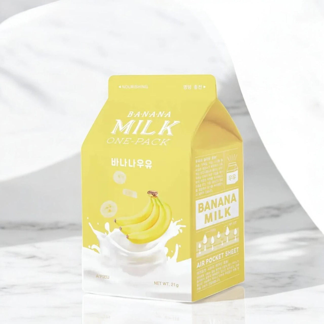 Skin TOGO A'pieu Milk One Pack banana sheet mask in a yellow carton-shaped package with milk and banana illustrations.