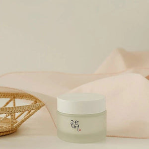 Skin TOGO Beauty of Joseon Dynasty Cream in a frosted glass jar with a white lid, set against a soft beige fabric.