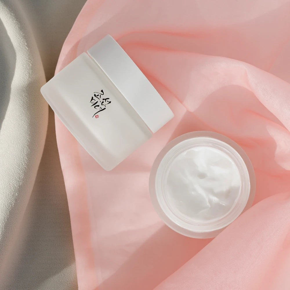 Skin TOGO Beauty of Joseon Dynasty Cream in a frosted glass jar with a white lid on a soft pink fabric background.