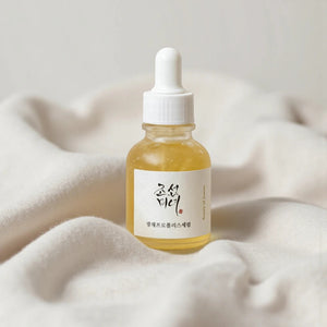 Skin TOGO Beauty of Joseon Glow Serum with propolis and niacinamide in a glass dropper bottle on soft fabric