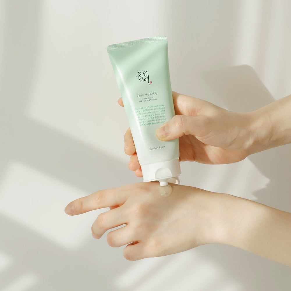 Skin TOGO Beauty of Joseon Green Plum Refreshing Cleanser being squeezed onto a hand, showing its clear gel texture.