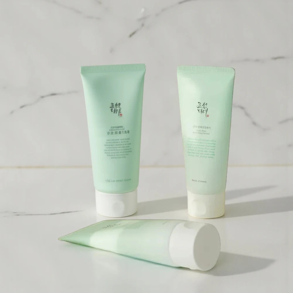 Skin TOGO Beauty of Joseon Green Plum Refreshing Cleanser tubes in light green packaging on a white marble surface.