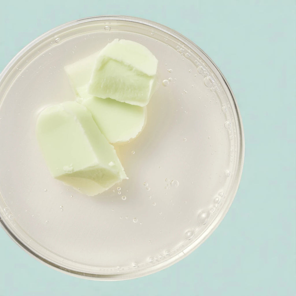 Skin TOGO Beauty of Joseon matte sun stick pieces with mugwort and camellia extract on a clear surface
