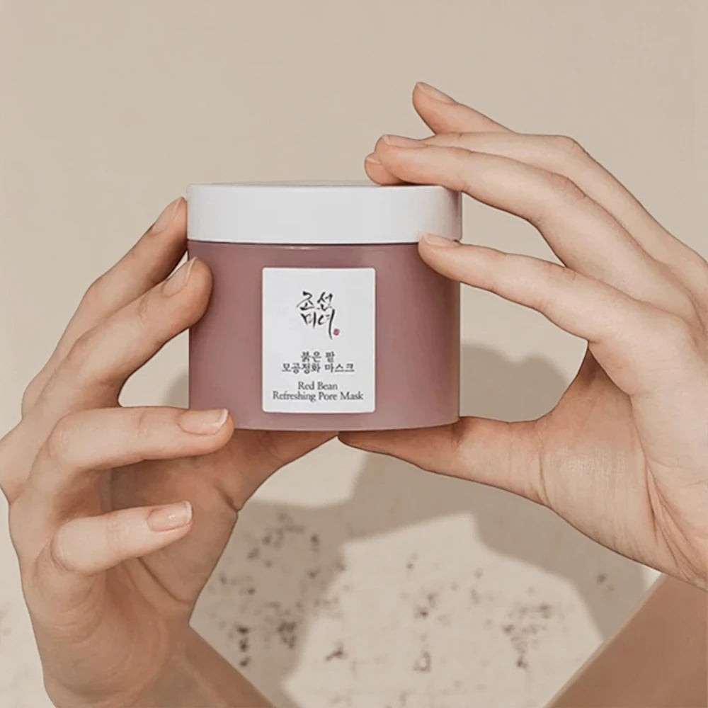 Skin TOGO Beauty of Joseon Red Bean Refreshing Pore Mask in a mauve jar held by hands against a neutral background