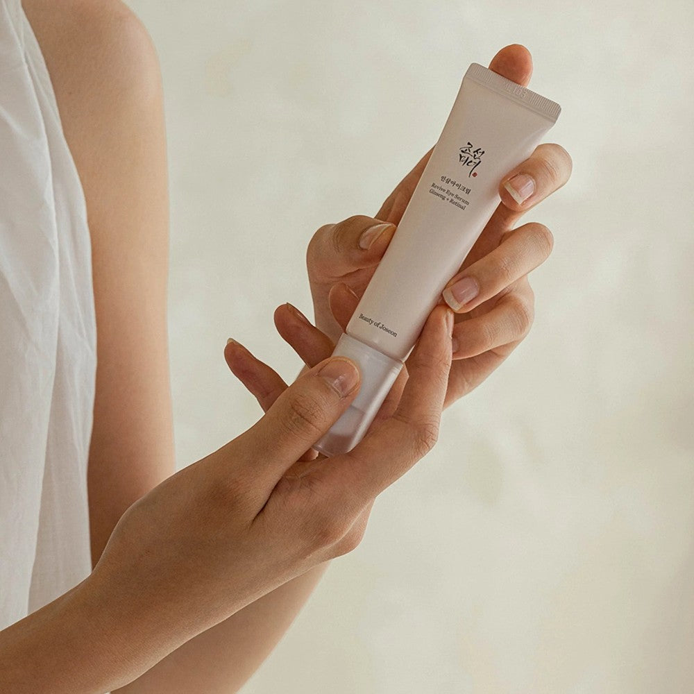 Skin TOGO Beauty of Joseon Revive Eye Serum with ginseng and retinal held in hands for anti-aging eye care.