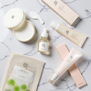 Skin TOGO collection of Beauty of Joseon skincare products including eye serum, sunscreen, and face mask on marble.