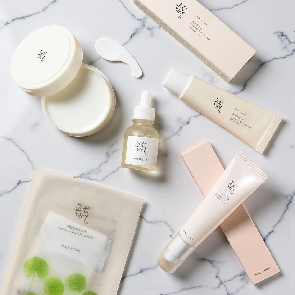 Skin TOGO collection of Beauty of Joseon skincare products including eye serum, sunscreen, and face mask on marble.