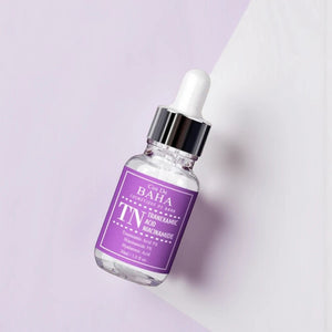 Skin TOGO Cos De BAHA TN Tranexamic Acid Niacinamide serum in a 30ml glass dropper bottle on a light purple background.