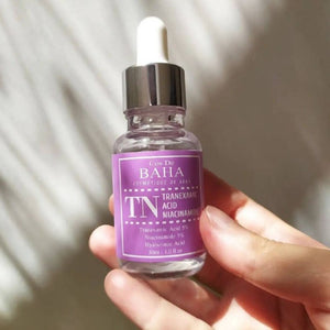 Skin TOGO Cos De BAHA TN Tranexamic Acid Niacinamide serum bottle held in hand for brightening skin tone