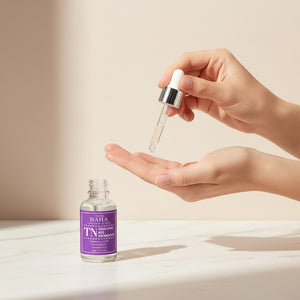 Skin TOGO Cos De BAHA TN Tranexamic Acid Niacinamide serum bottle with dropper being applied to a hand