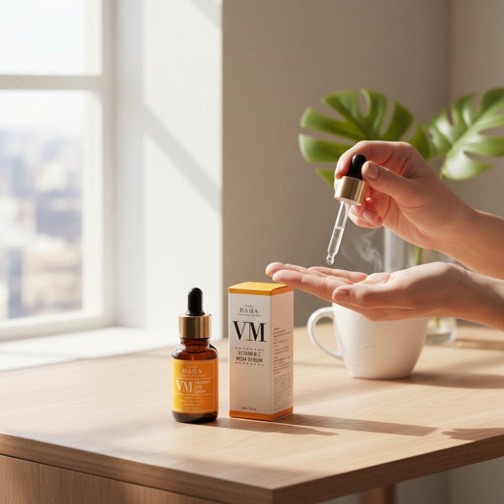 Skin TOGO Cos De BAHA VM Vitamin C MSM serum bottle and box on a wooden table with a hand using the dropper