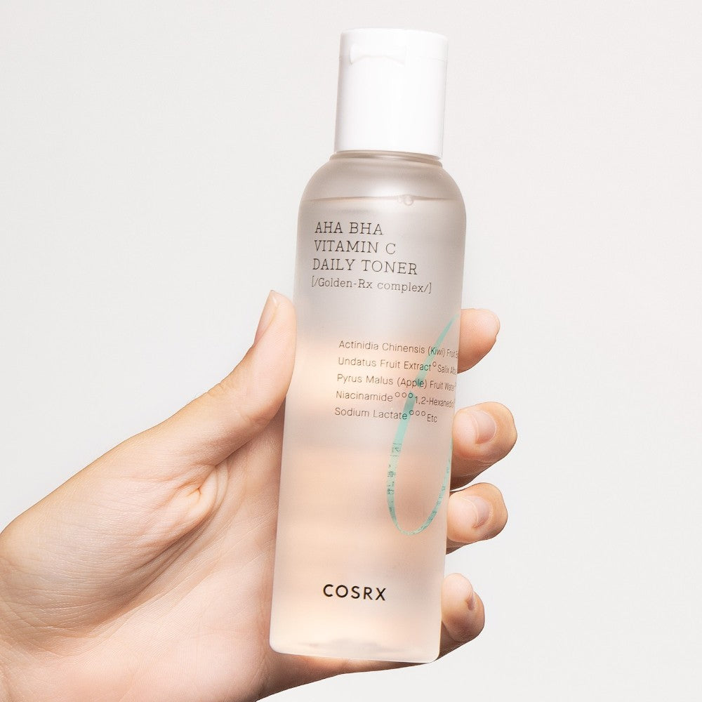 Skin TOGO COSRX AHA BHA Vitamin C Daily Toner in a clear 150ml bottle held in a hand for skincare routine