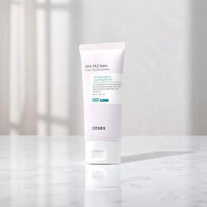 Skin TOGO COSRX Aloe 54.2 Aqua Tone-Up Sunscreen SPF50+ in a white tube on a marble surface with soft lighting.