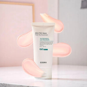 Skin TOGO COSRX Aloe 54.2 Aqua Tone-Up Sunscreen tube with pink cream swatches on a white surface