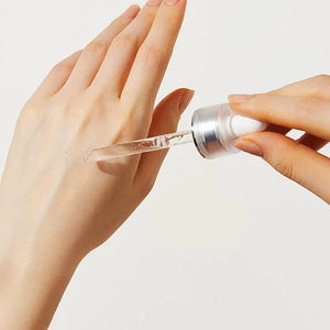 Skin TOGO COSRX Blemish Spot Clearing Serum with a clear gel texture being applied to the back of a hand with a dropper