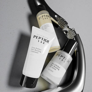 Skin TOGO COSRX Peptide-132 hair care set including bonding oil serum, treatment, and shampoo on a grey surface.