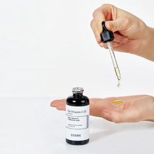 Skin TOGO Cosrx The Vitamin C 23 Serum being applied with a dropper onto a palm for skincare routine