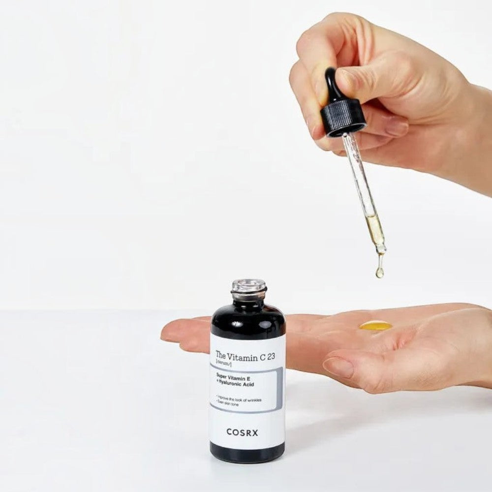 Skin TOGO Cosrx The Vitamin C 23 Serum being applied with a dropper onto a palm for skincare routine