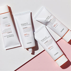 Skin TOGO COSRX Vitamin E Vitalizing Sunscreen SPF 50+ tubes arranged on a light pink surface