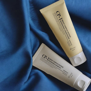 Skin TOGO CP-1 Bright Complex Intense Nourishing shampoo and conditioner tubes on blue fabric background