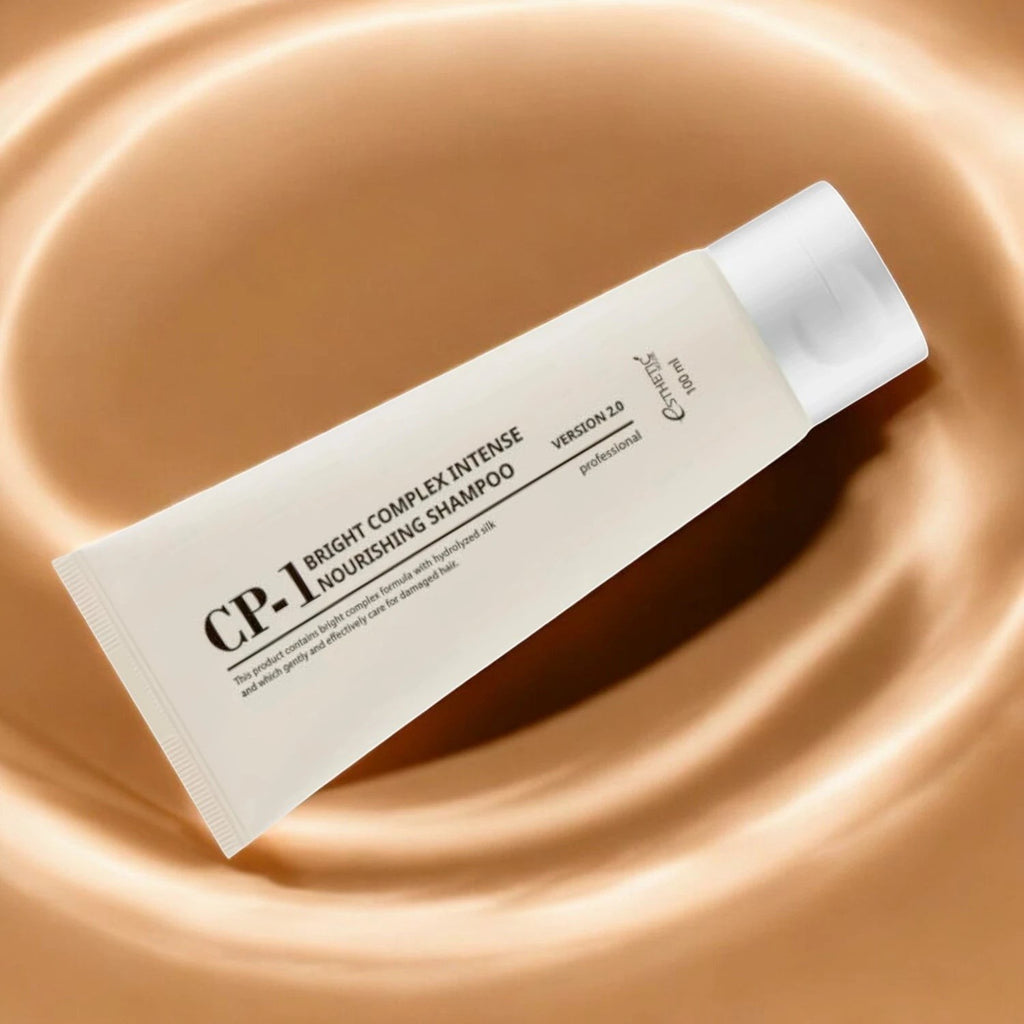 Skin TOGO CP-1 Bright Complex Intense Nourishing Shampoo in a 100ml white tube resting on a swirling beige background.