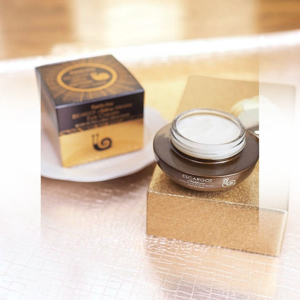 Skin TOGO Farmstay Escargot Noblesse Intensive Eye Cream in a brown jar with its gold and black packaging box