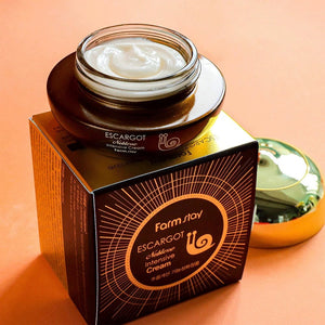 Skin TOGO Farmstay Escargot Noblesse Intensive Eye Cream in a brown jar with snail secretion extract on its box.