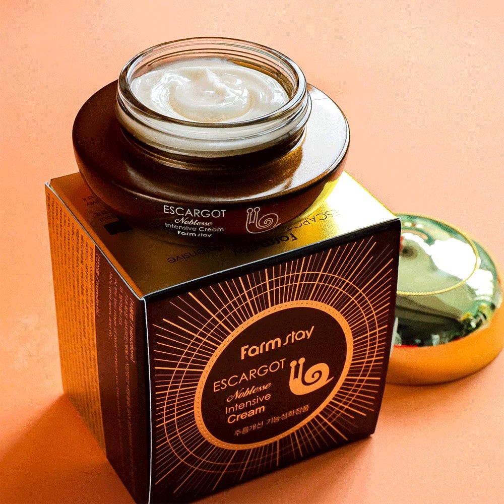 Skin TOGO Farmstay Escargot Noblesse Intensive Eye Cream in a brown jar with snail secretion extract on its box.