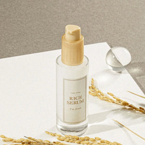 Skin TOGO I'm from Rice Serum in a 30ml glass bottle with a pump, featuring rice stalks on a white surface.