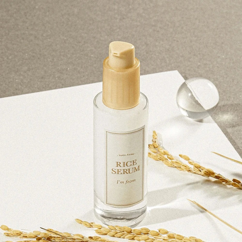 Skin TOGO I'm from Rice Serum in a 30ml glass bottle with a pump, featuring rice stalks on a white surface.