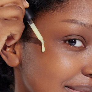 Skin TOGO model applying Isntree Hyper Retinol Ex 1.0 Serum with a dropper onto her cheek for anti-aging skincare.