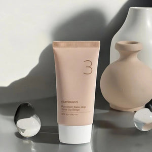 Skin TOGO Numbuzin No.3 Porcelain Base-Skip Tone Up Beige BB cream tube with SPF 50+ on a minimalist grey surface.