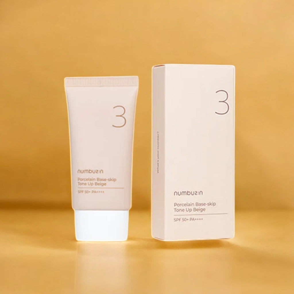 Skin TOGO Numbuzin No.3 Porcelain Base-Skip Tone Up Beige BB cream tube and its white packaging box on a gold background.