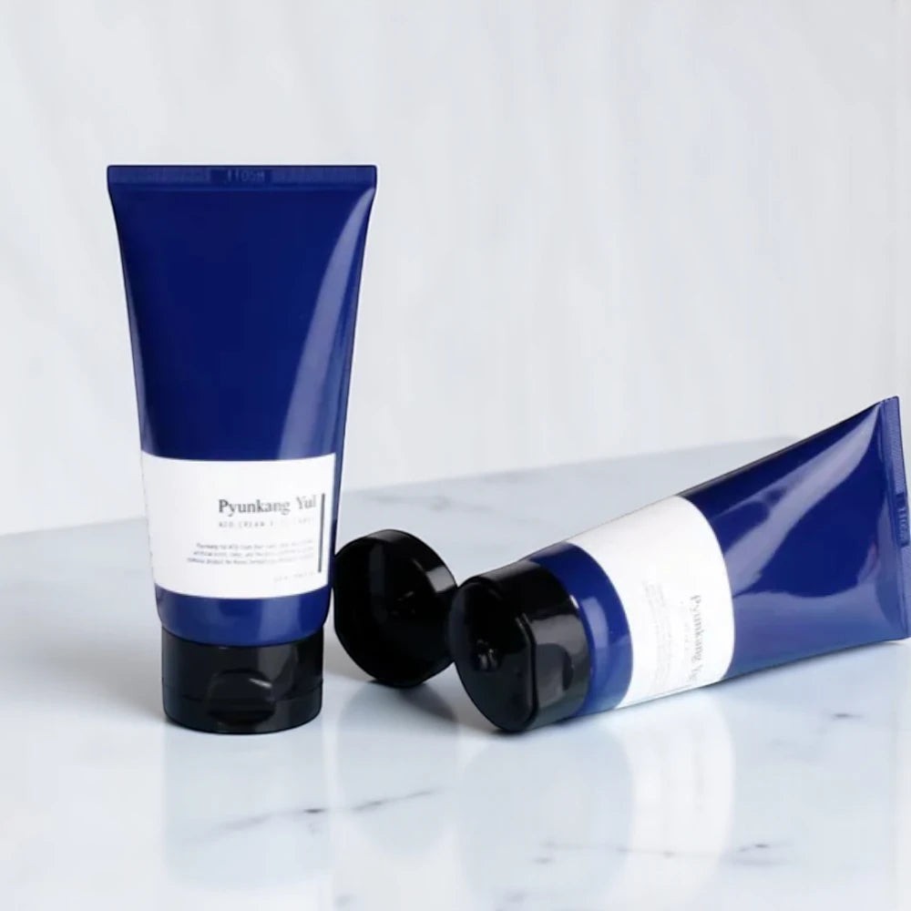 Skin TOGO Pyunkang Yul ATO Cream Blue Label in a blue squeeze tube for sensitive and atopic skin on a marble surface.