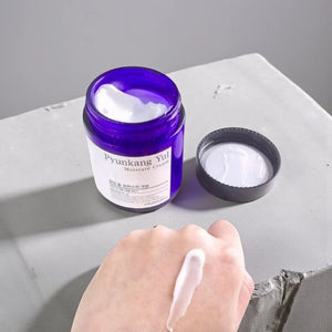 Skin TOGO Pyunkang Yul Moisture Cream in a blue jar with white cream swatched on a hand for sensitive skin