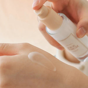 Skin TOGO I'm from Rice Serum being applied to hand, showing the lightweight, clear texture of the brightening formula.