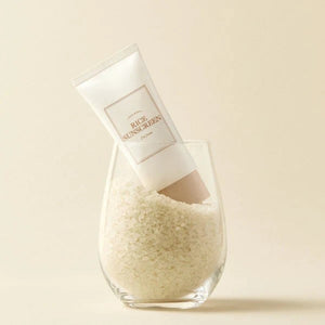 Skin TOGO I'm from Rice Sunscreen SPF50+ in a glass filled with white rice grains for a clean aesthetic.
