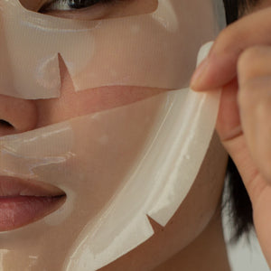 Skin TOGO Seoul Girl's Beauty Secret moisturizing sheet mask being applied to a person's face for deep hydration.