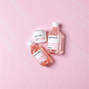 Skin TOGO SNP Prep Peptaronic skincare set including toner, serum, and cream in pink packaging on a pink background.