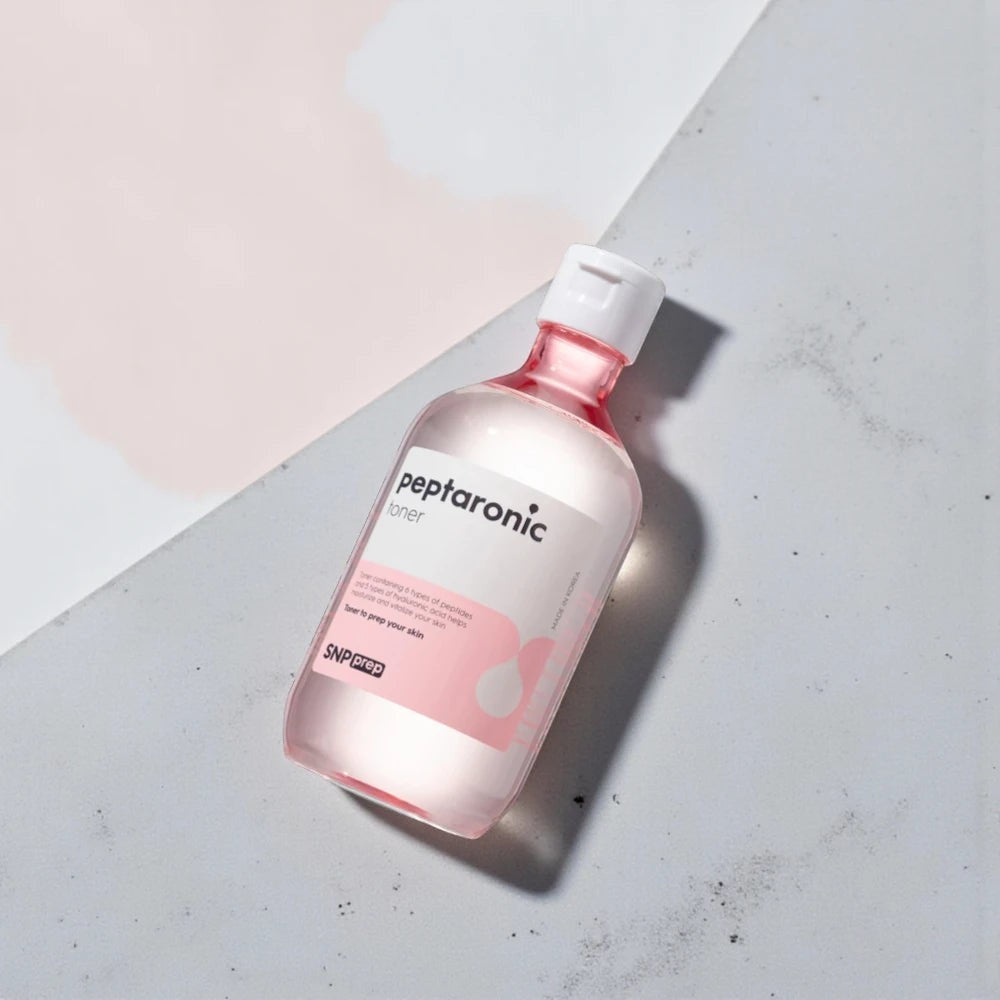 Skin TOGO SNP Prep Peptaronic Toner in a 320ml bottle with pink accents, formulated with peptides and hyaluronic acid.