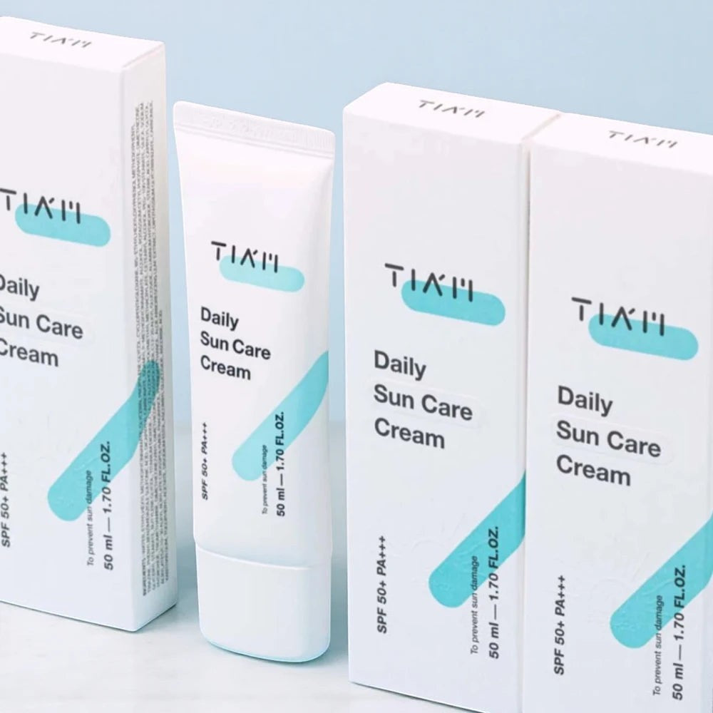 Skin TOGO TIAM Daily Sun Care Cream SPF 50+ tubes and boxes in white and light blue packaging.