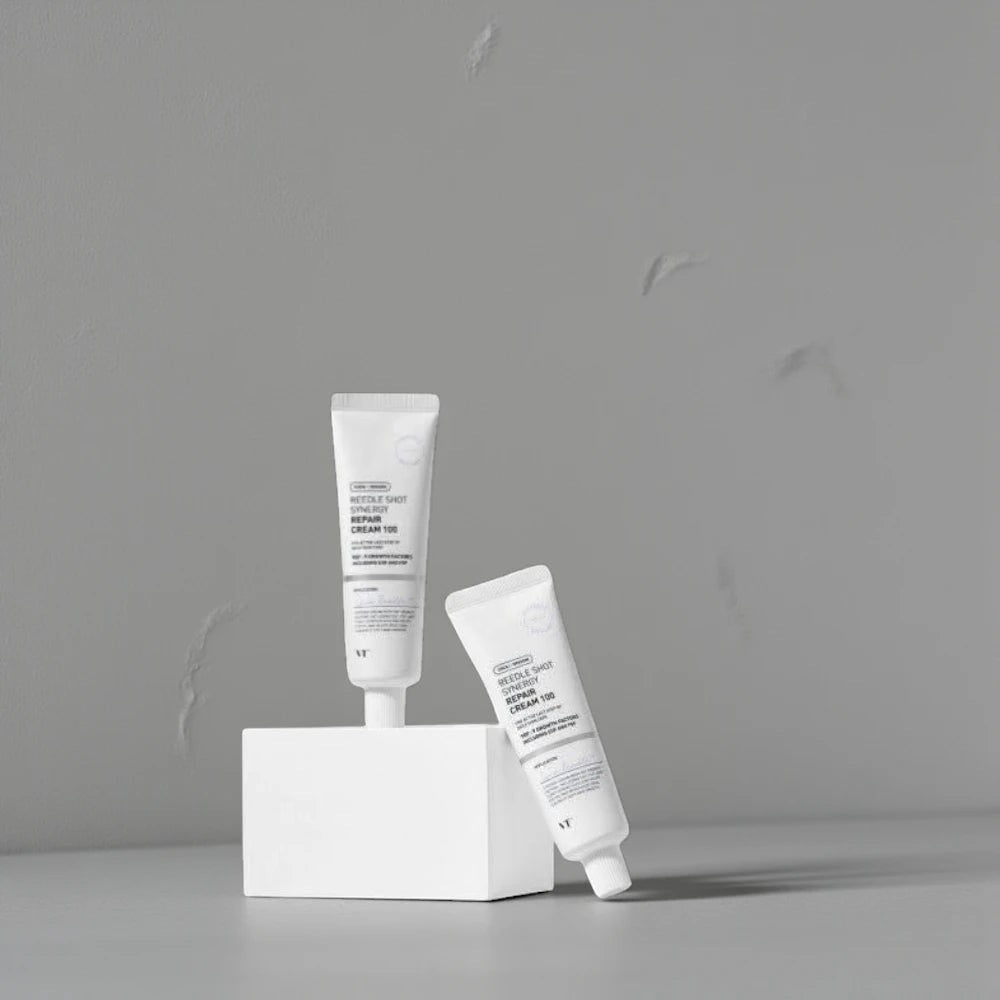 Skin TOGO VT Cosmetics Reedle Shot Synergy Repair Cream tubes displayed on a white block against a grey background.